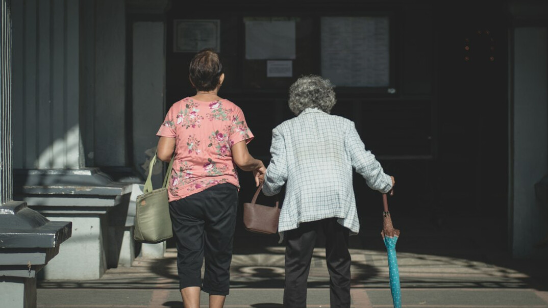 Adult daughter visiting her elderly mother at the club
