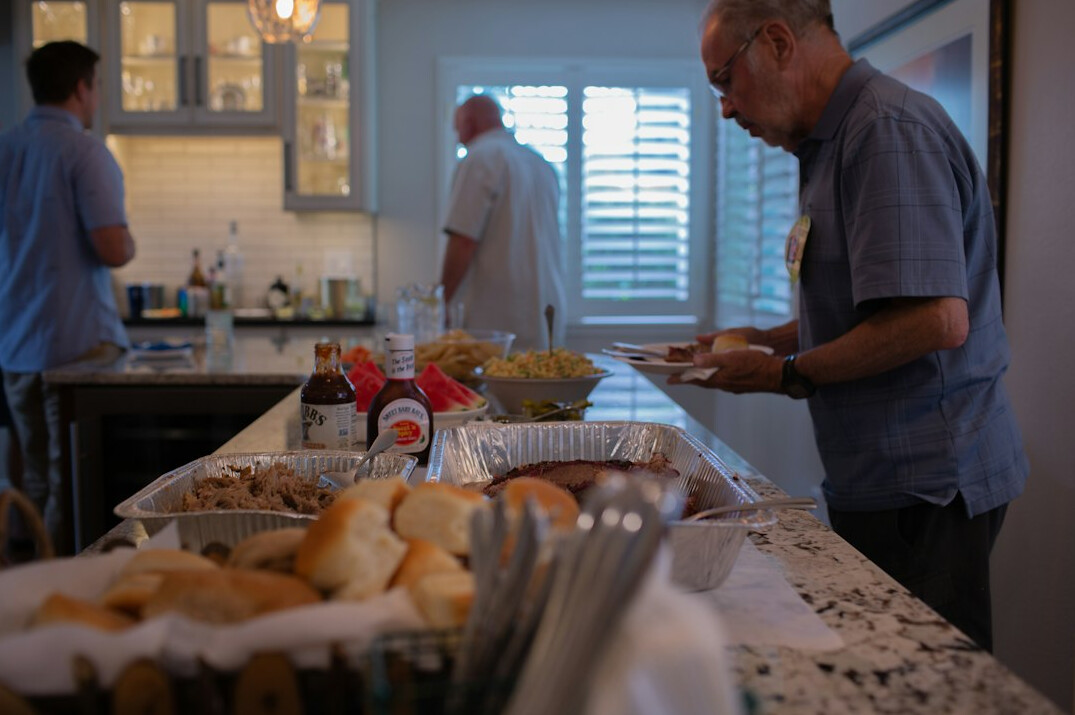 Seniors cooking together in a communal kitchen