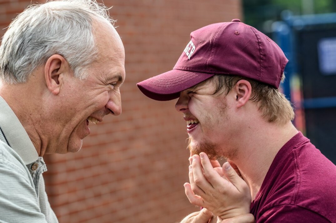 Younger volunteer helping an elderly neighbor