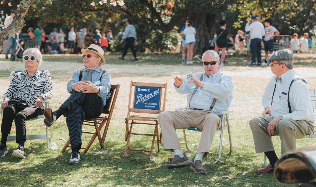 elderly friends chatting in park